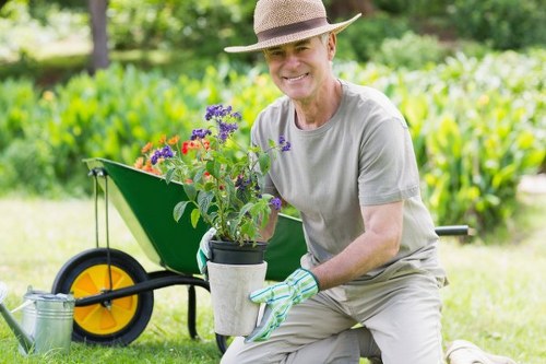 Gardener preparing soil in Highgate garden